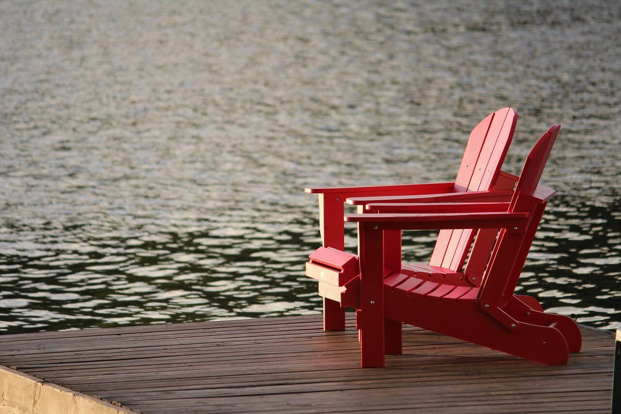 empty chairs by the water