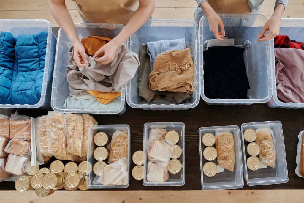 Volunteers putting together food and clothing packages